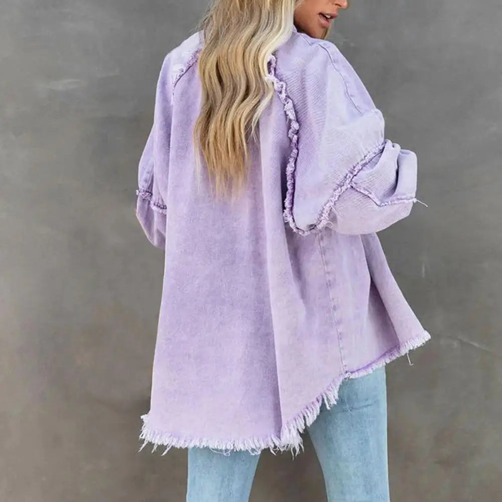 Oversized women's denim jacket by Corporación Turística, casual streetwear style, shown hanging on a clothing rack.