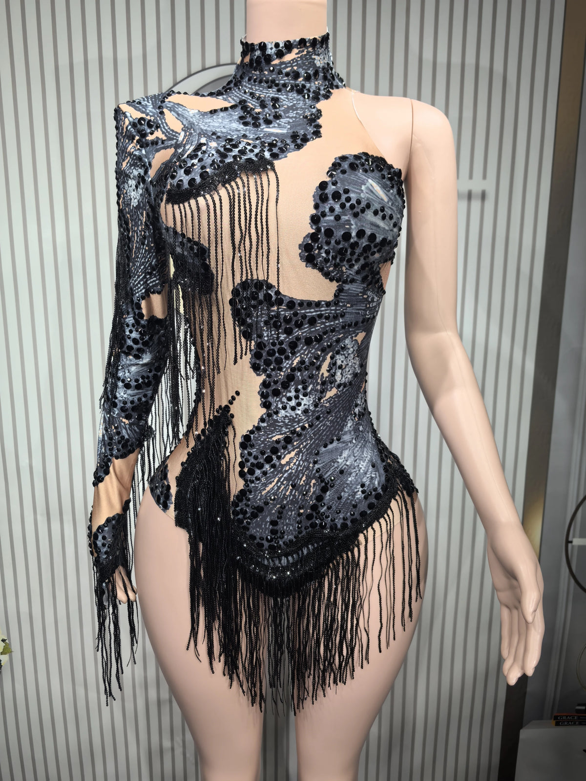 Close-up of a fitted sexy women's dance leotard with fringe details, made by Corporación Turística.