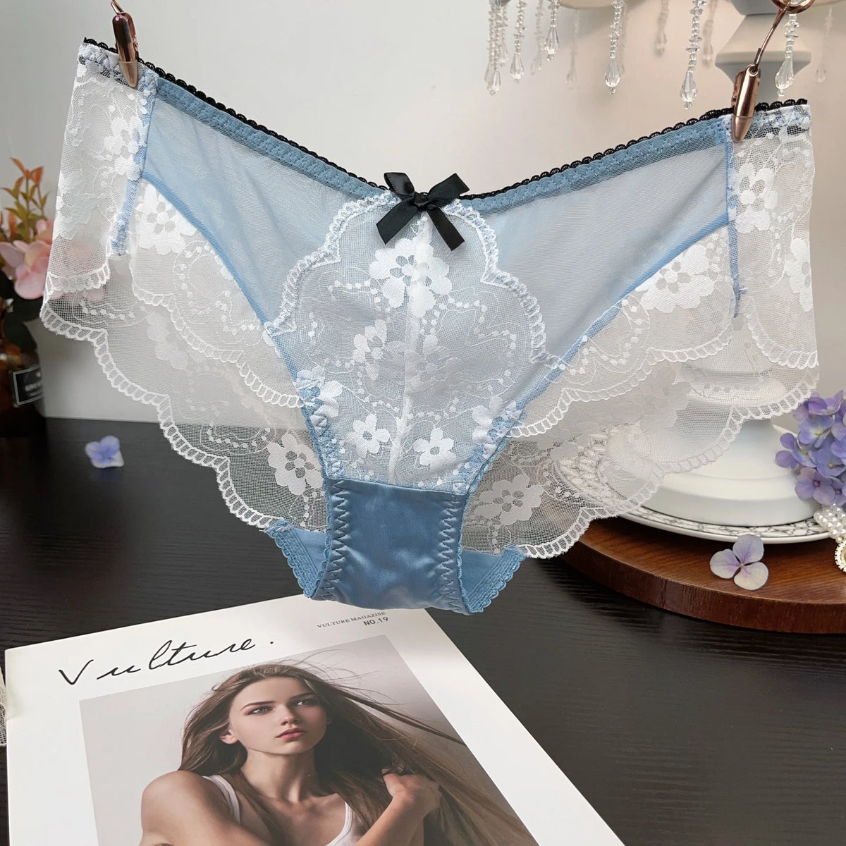 Set of three fashionable embroidered lace underwear by Corporación Turística, featuring intricate lace details and comfortable fit.