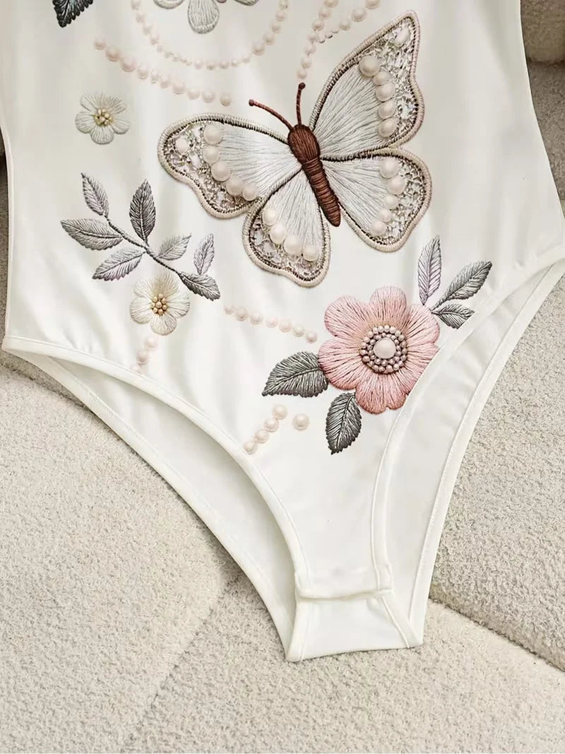 Elegant floral embroidered butterfly body suit for women, featuring intricate lace and delicate design from Corporación Turística.