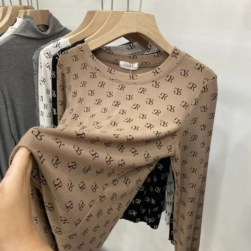 Long-sleeve printed women's t-shirt by Corporación Turística featuring colorful graphic design on soft fabric.