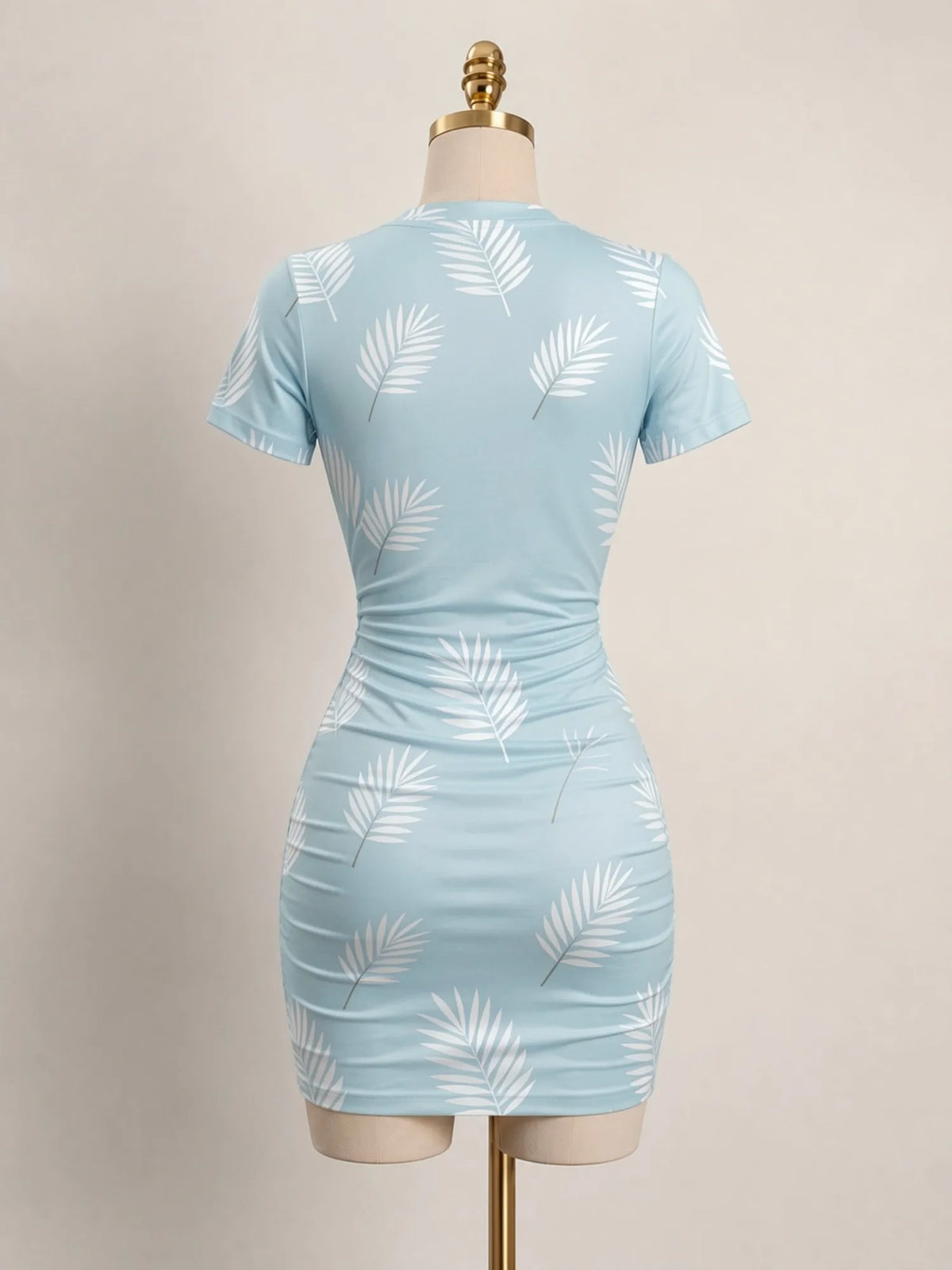 Close-up of a fitted women's short-sleeve mini dress with a high neckline from Corporación Turística, showing the fabric and design details.