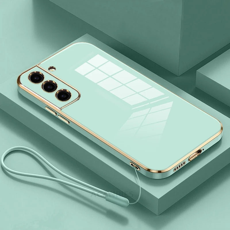 Silicone cord cover with gold-plated accents, designed by Corporación Turística, featuring a sleek, flexible silicone material with a cord attachment.