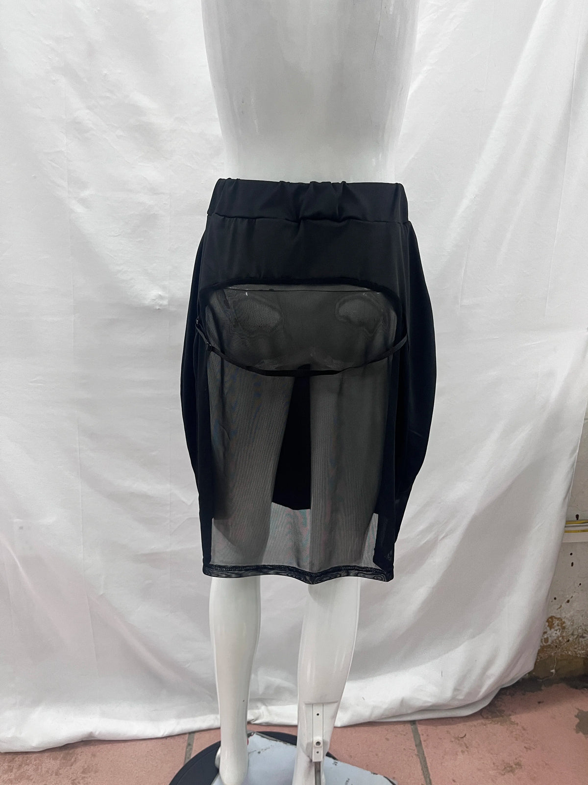 Black fitted midi mesh skirt with transparent panels, stylish and trendy from Corporación Turística.