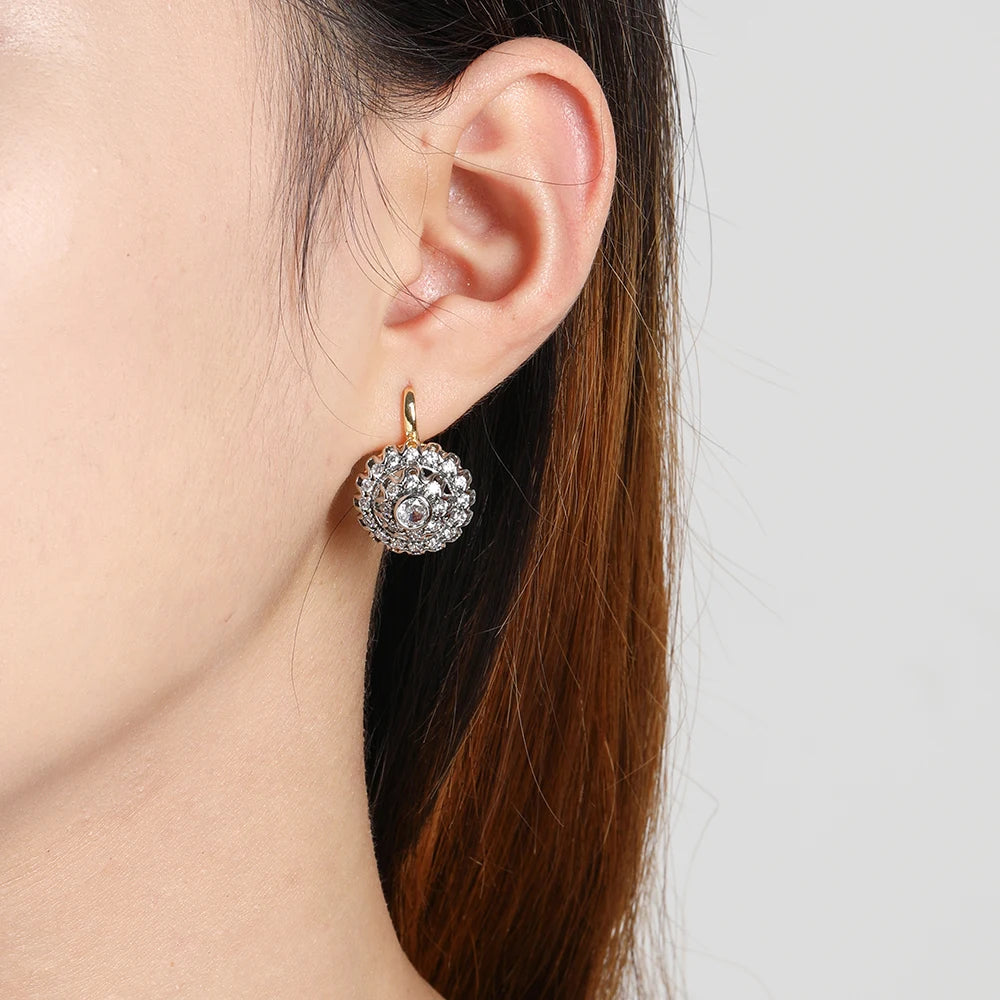 Vermiculite earrings with cone inlays from Corporación Turística, showcasing intricate surface details and natural mineral textures.