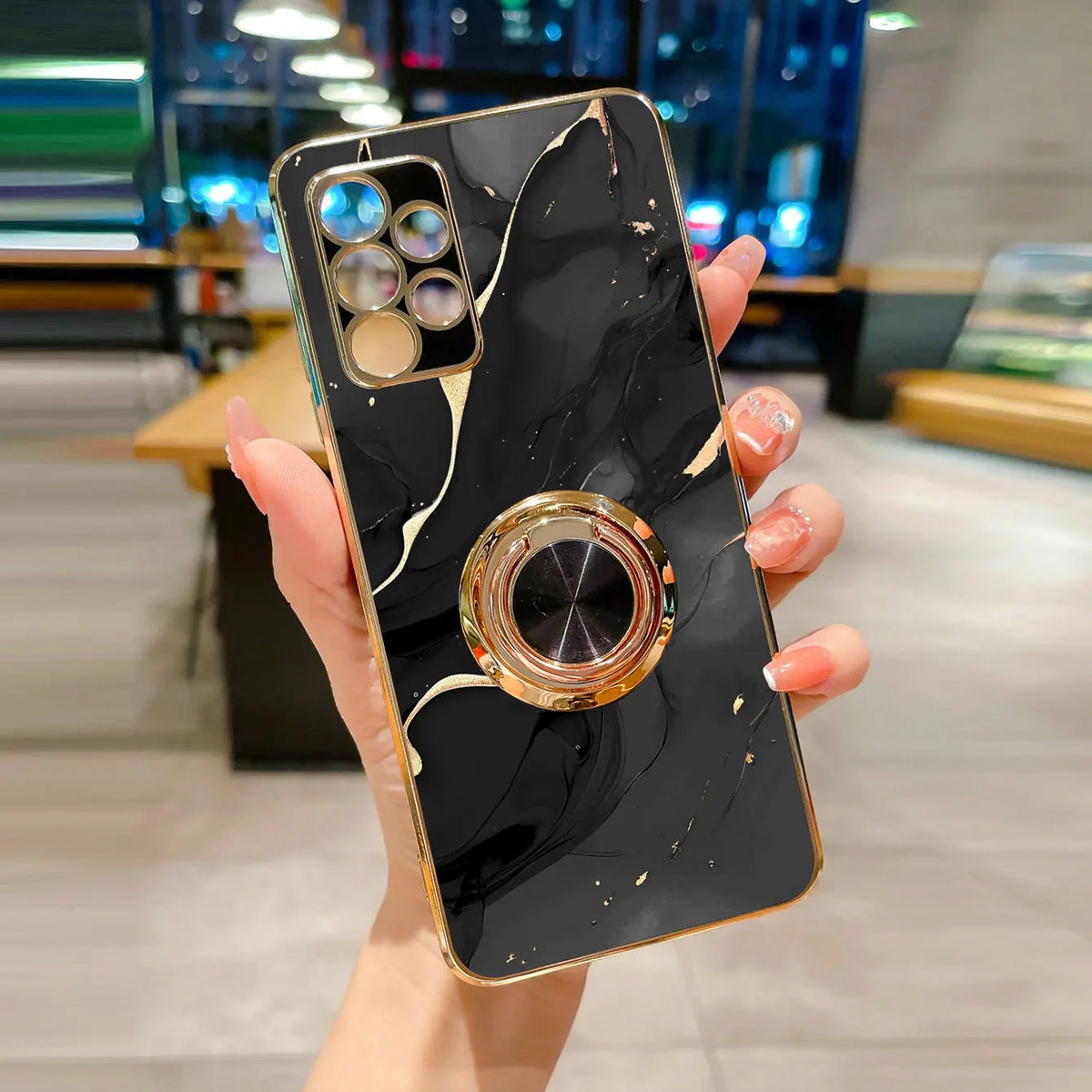 Phone case with ring stand featuring a marble pattern, designed by Corporación Turística, showcasing the stylish protective cover.