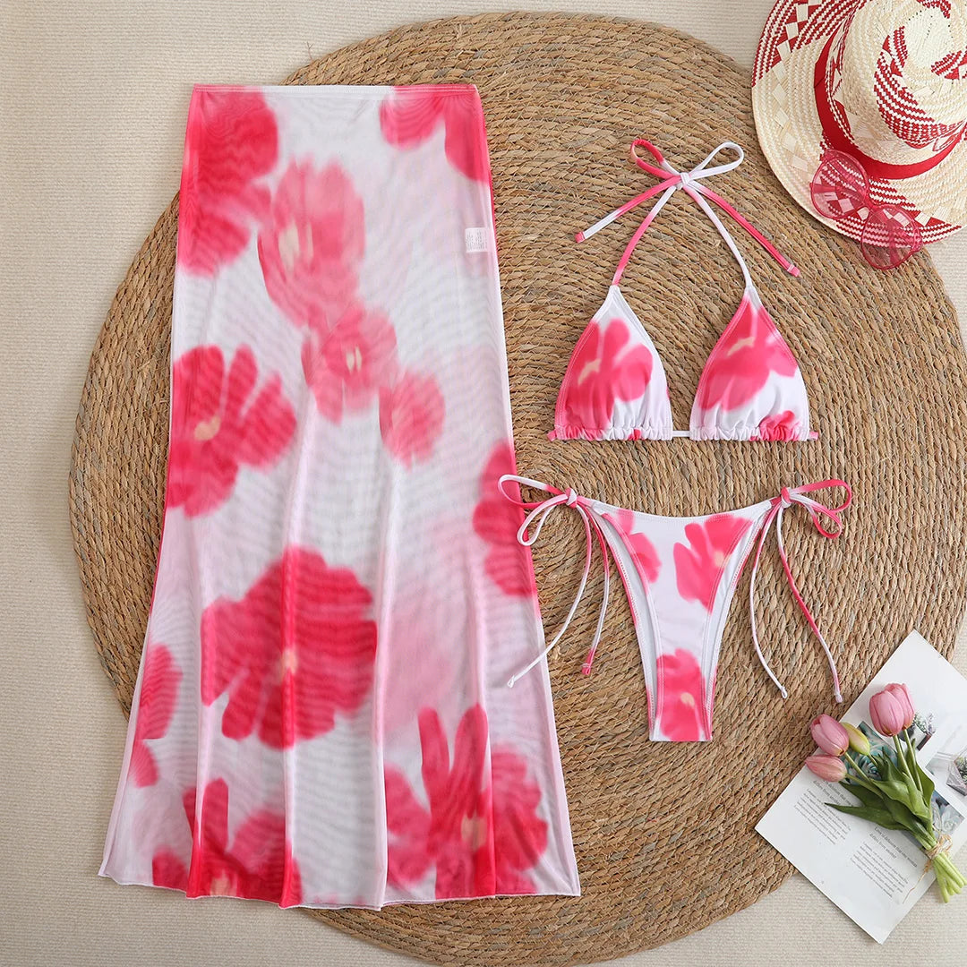 Colorful floral print bikini with matching skirt, stylish swimwear by Corporación Turística, perfect for summer beach days.