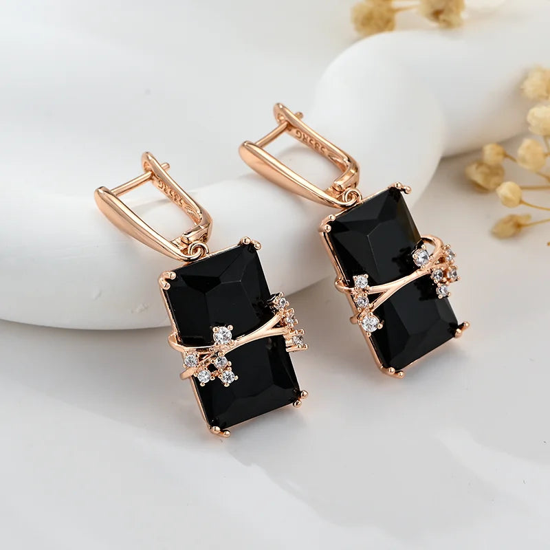 Long black square stone earrings from Corporación Turística, featuring elegant geometric design and silver hooks.
