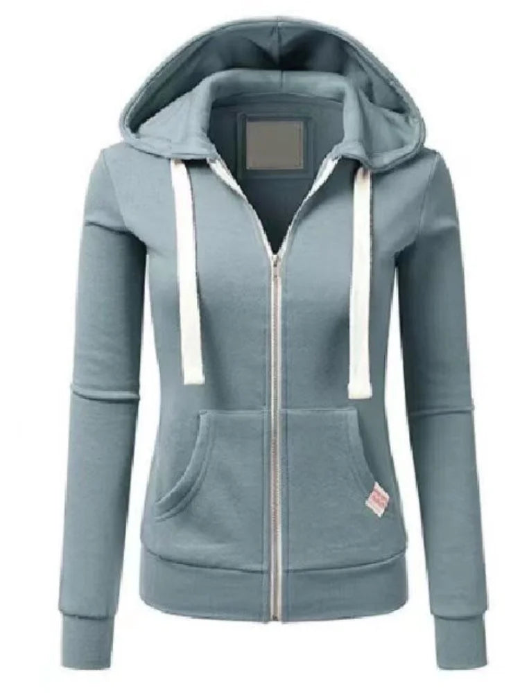 Casual urban women's hoodie sweatshirt in black with front pocket, from Corporación Turística, shown on a model.