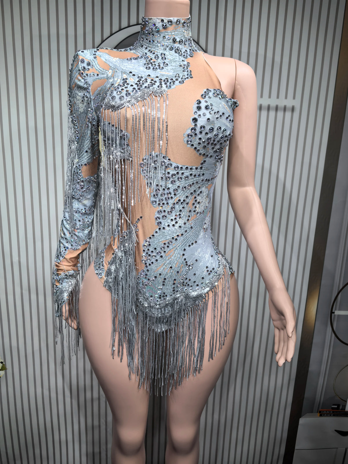 Close-up of a fitted sexy women's dance leotard with fringe details from Corporación Turística.