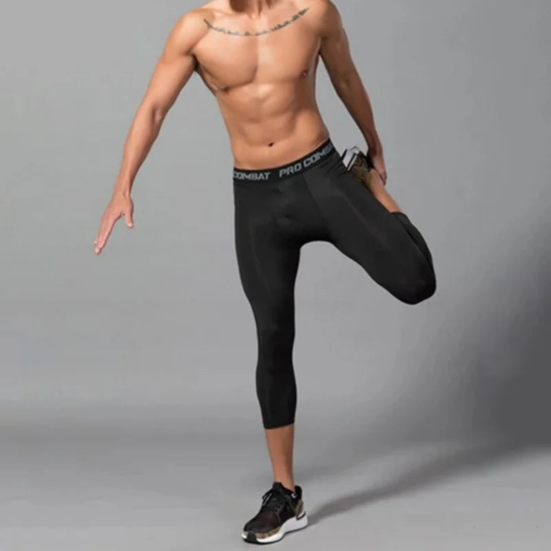 Men's compression shorts leggings from Corporación Turística, close-up view of black athletic shorts with stretch fabric.