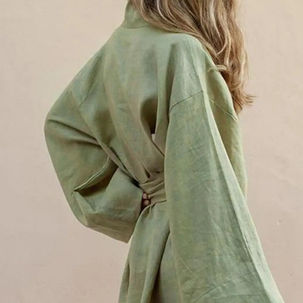Long-sleeve V-neck minidress with tie-front details, featuring a stylish design by Corporación Turística.