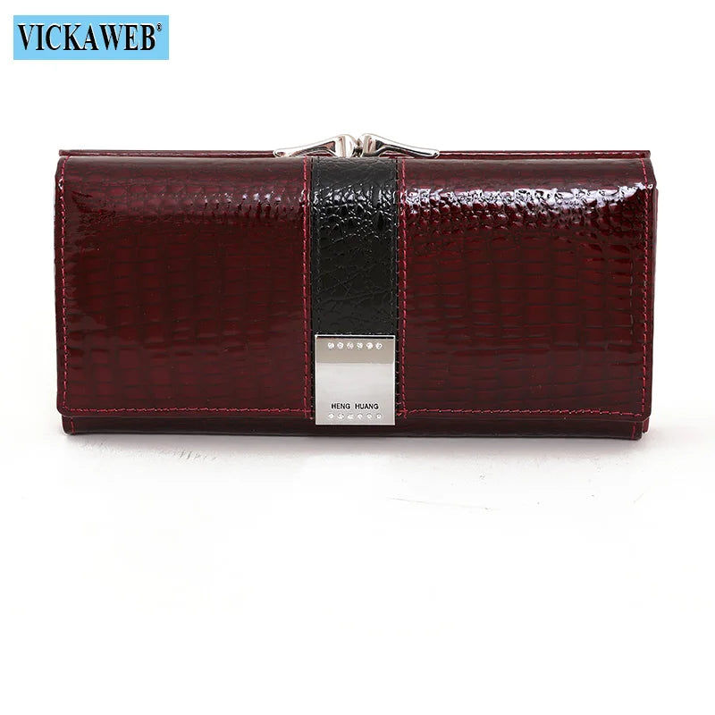 Long leather wallet in patent finish by Corporación Turística, featuring multiple card slots and a sleek design.
