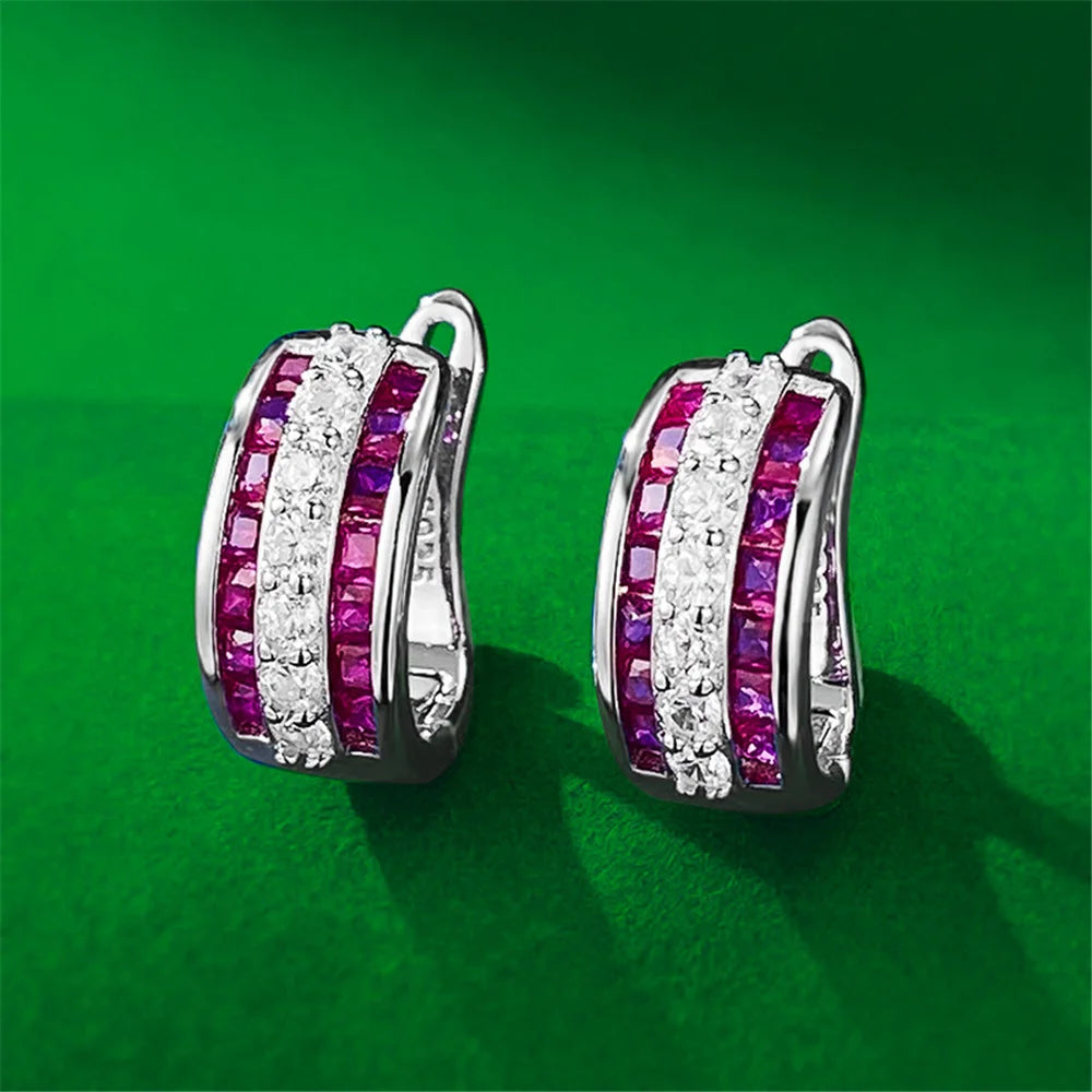 Round hoop earrings with white cubic zirconia stones, stylish jewelry by Corporación Turística, showcasing intricate metalwork and sparkle.