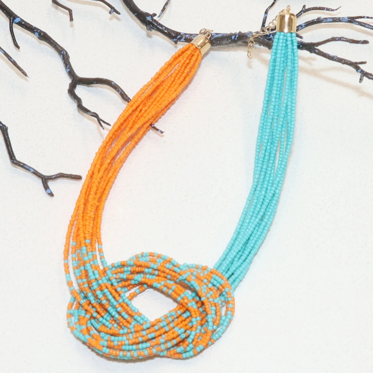Ethnic-style rice bead necklace from Corporación Turística, featuring colorful, handcrafted design with intricate details.