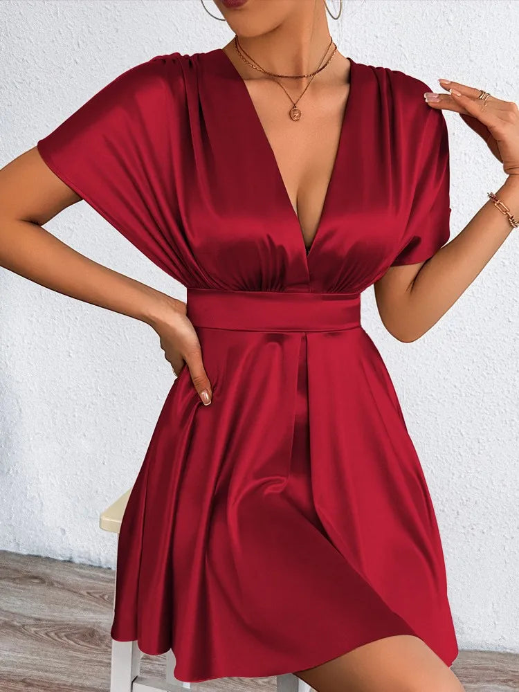 Elegant sexy dress with V-neckline and low waist, featuring smooth fabric and fitted silhouette, by Corporación Turística.
