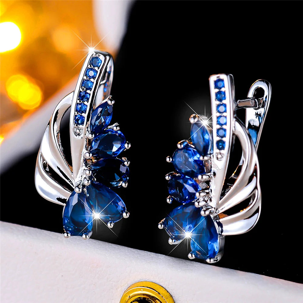 Elegant clip-on earrings in green and blue luxury design for women, featuring intricate details and vibrant gemstones.