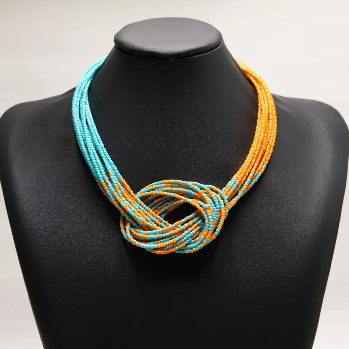 Ethnic style rice bead necklace from Corporación Turística, showcasing colorful handcrafted jewelry with intricate beadwork.