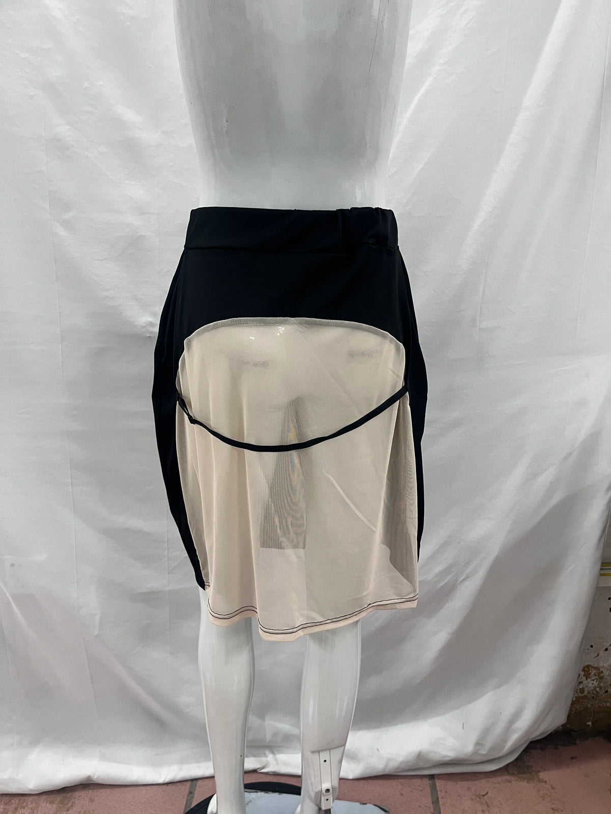 Black fitted mesh midi skirt with transparent panels from Corporación Turística, stylish and modern for fashionable looks.