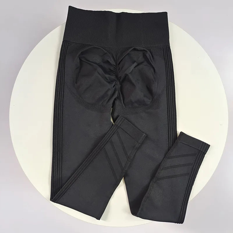 High-waisted women's yoga leggings in stretchy fabric, shown in black, designed for comfort and flexibility during exercise.