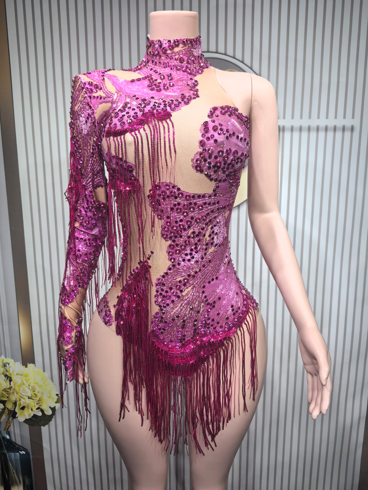 Close-up of a women's tight sexy leotard dance costume with fringe details, designed for performance and stylish movement.