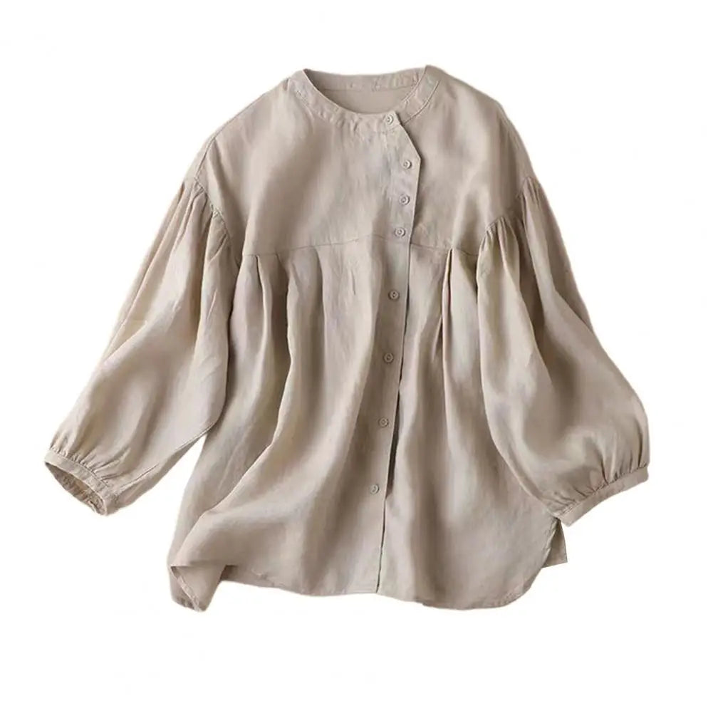 Light-colored women's retro blouse with loose fit and balloon sleeves, stylish casual top by Corporación Turística.
