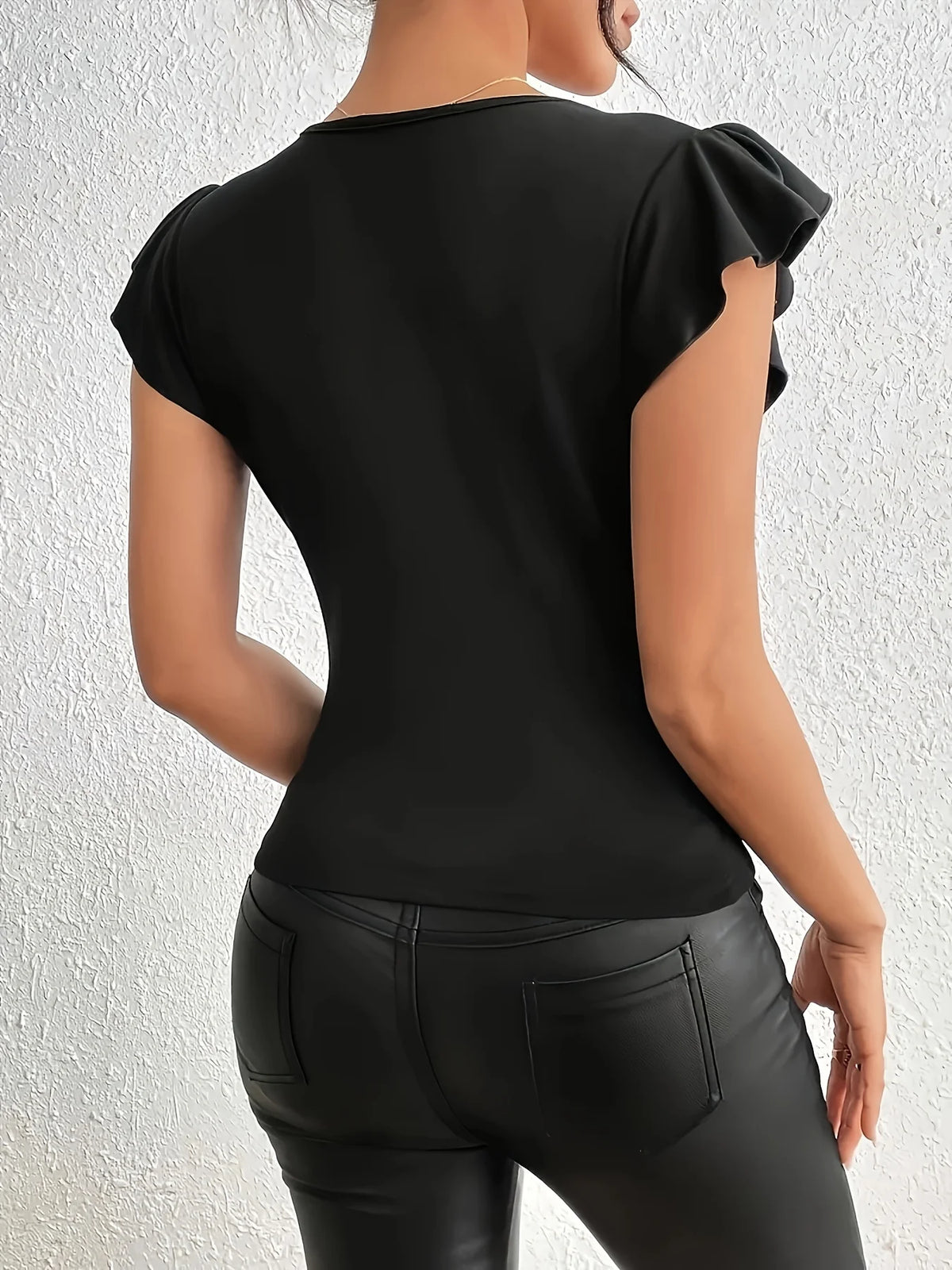 Body sexy con escote profundo en V, transparencias y manga larga, diseñado por Corporación Turística, visible in the image.