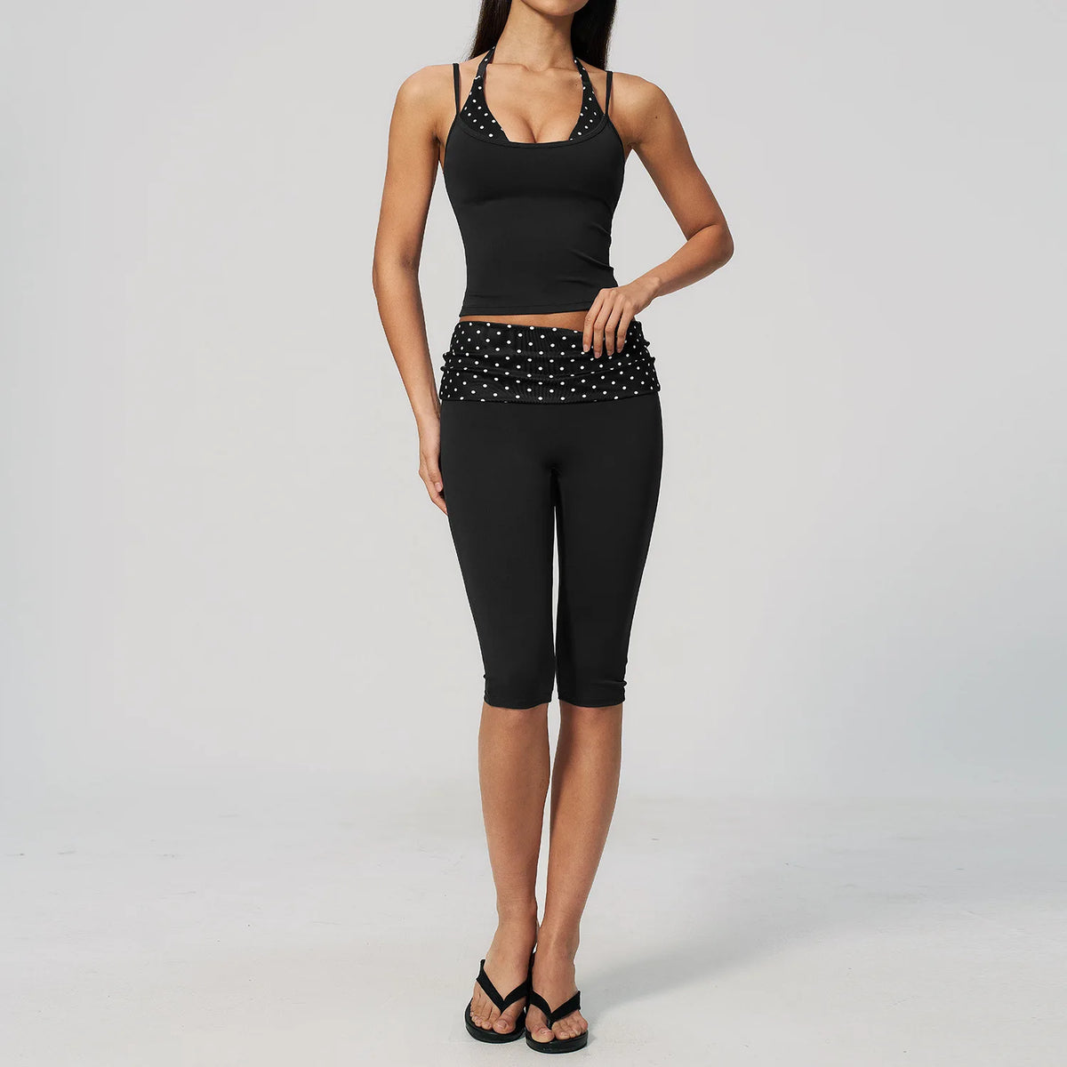 Two-piece women's yoga set featuring a padded crop top and matching leggings, in comfortable, breathable fabric.