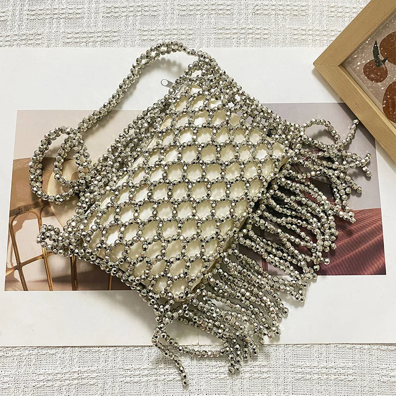 Handmade woven tote bag with beaded details and tassels, crafted by Corporación Turística, featuring colorful embroidery and natural fiber.