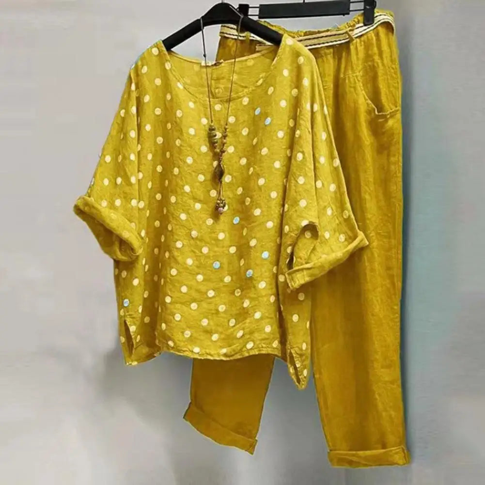 Light pastel spring and summer women's blouse and pants set by Corporación Turística, displayed on a hanger.