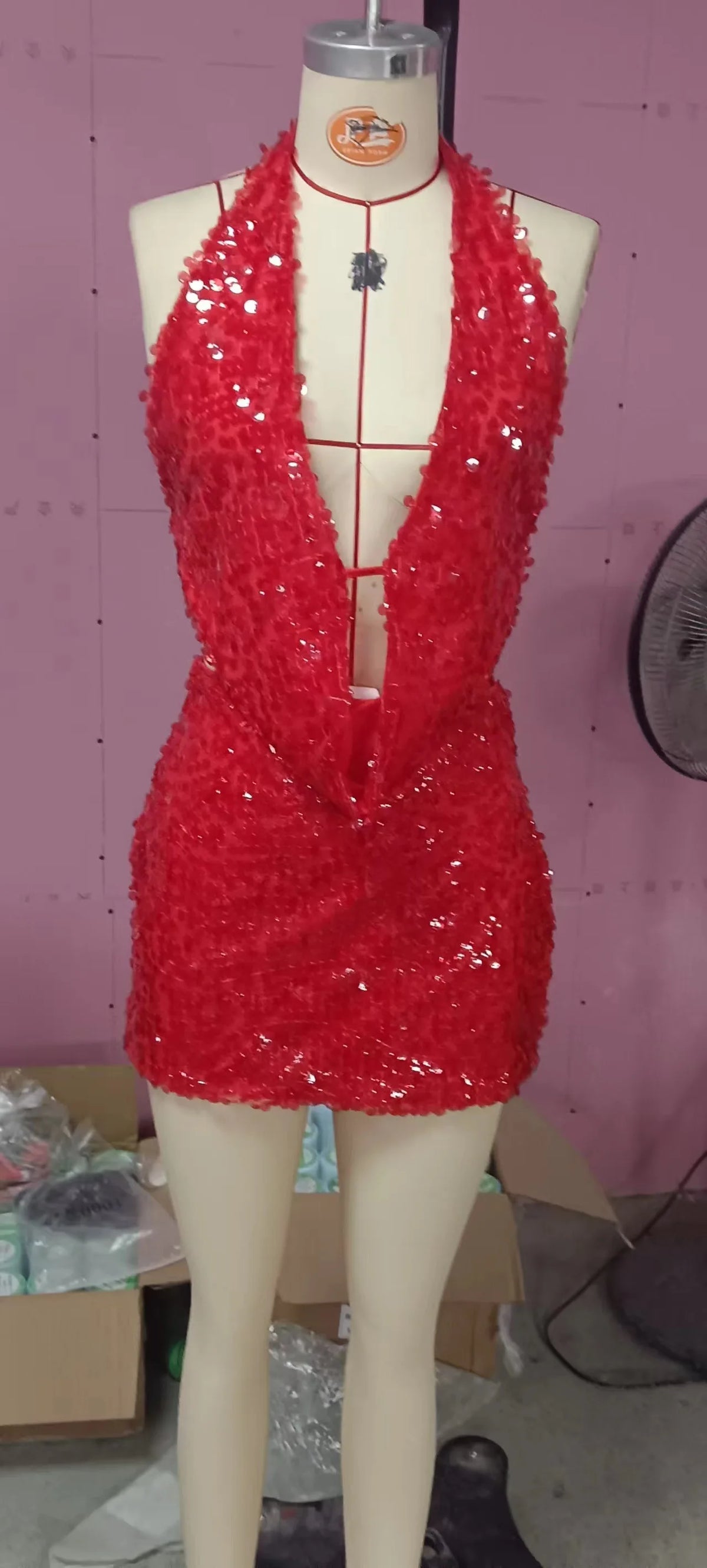 Two-piece sexy sequin outfit with sleeveless top and matching bottoms, vibrant and glamorous fashion by Corporación Turística.