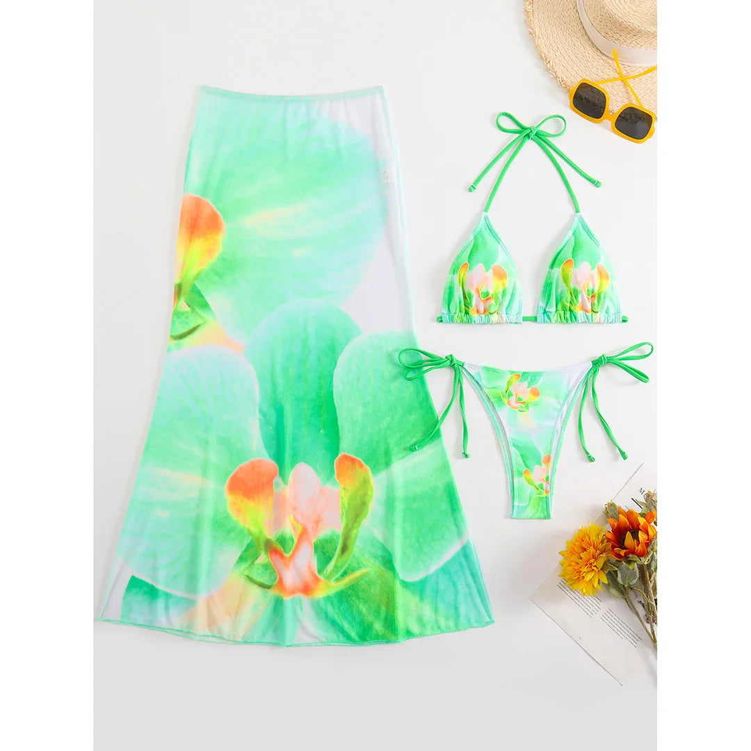 Colorful floral bikini with matching skirt, stylish swimwear by Corporación Turística, perfect for beach or poolside wear.