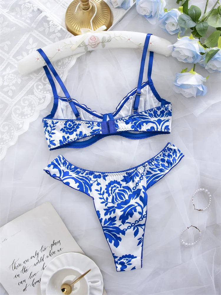 Blue floral print women's lingerie set with matching bra and panties from Corporación Turística, displayed on a flat surface.