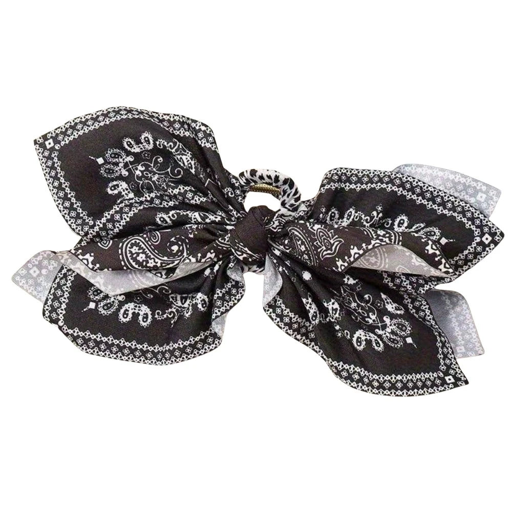 Elegant hair clip with a floral bow design, perfect for securing and styling hair with a charming touch.
