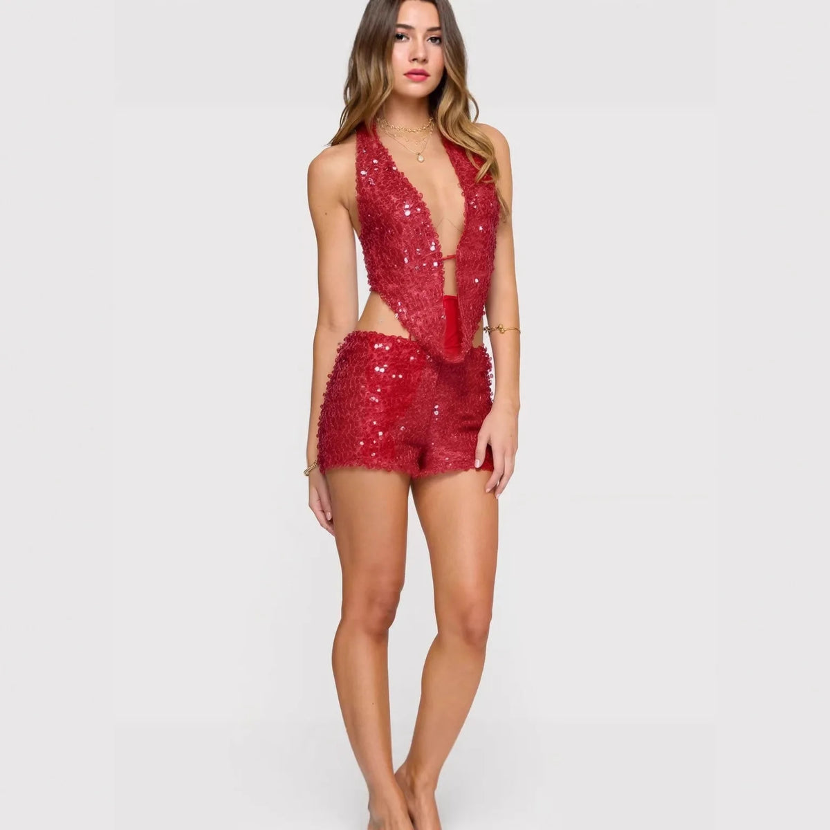 Two-piece sexy sequin outfit with sleeveless top, featuring shiny embellishments, designed for stylish evening wear.