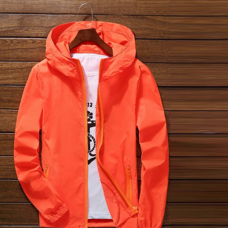 Quick-drying cycling and running raincoat by Corporación Turística, lightweight waterproof jacket with hood and breathable fabric.