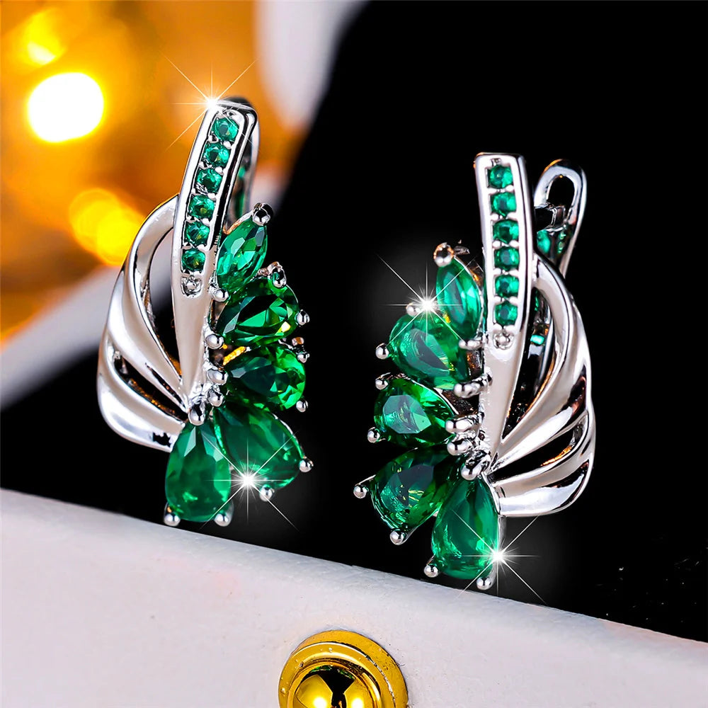 Elegant clip-on earrings with green and blue gemstones, luxury jewelry for women, by Corporación Turística.