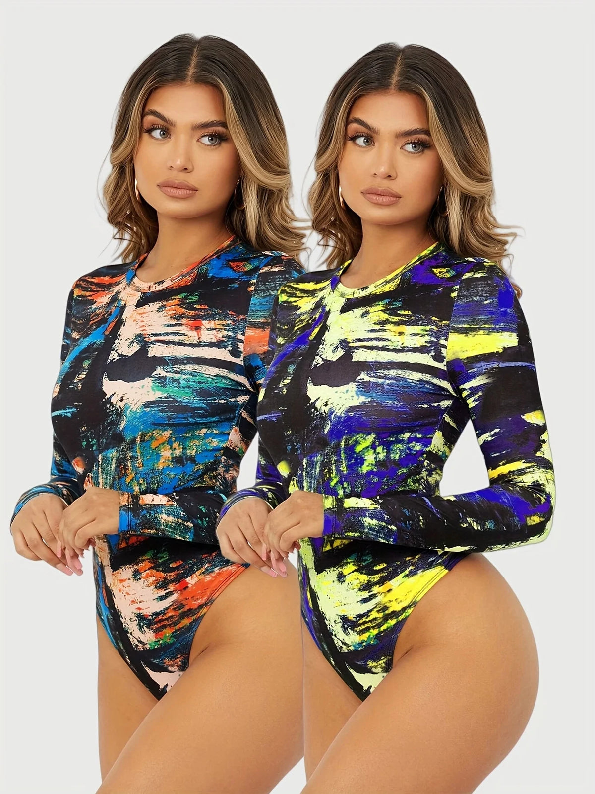 Two women's body shirts with round neck and floral print from Corporación Turística, displayed on a hanger.