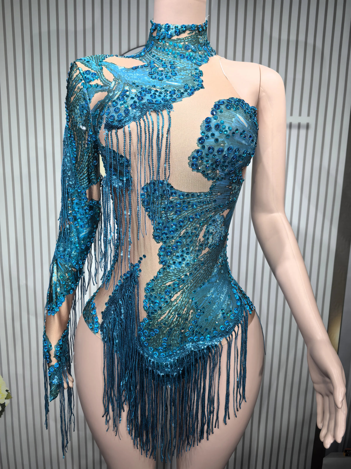 Close-up of a fitted sexy women's dance leotard with decorative fringe, in black, by Corporación Turística.