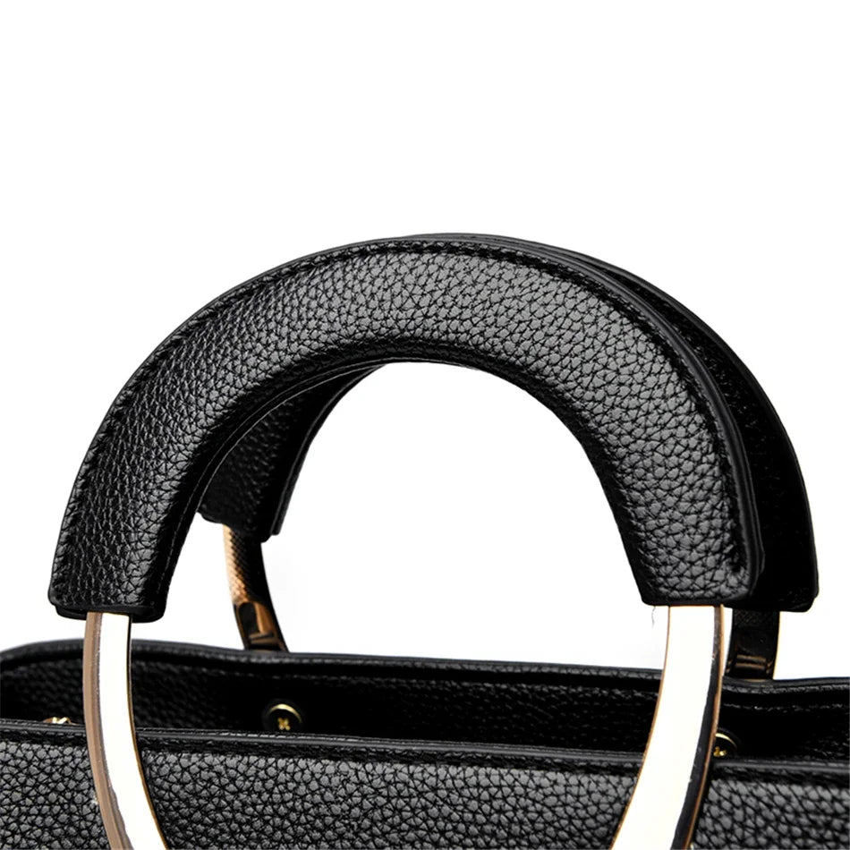 VANDERWAH genuino synthetic leather casual handbag with adjustable strap, black color, and minimalist design.