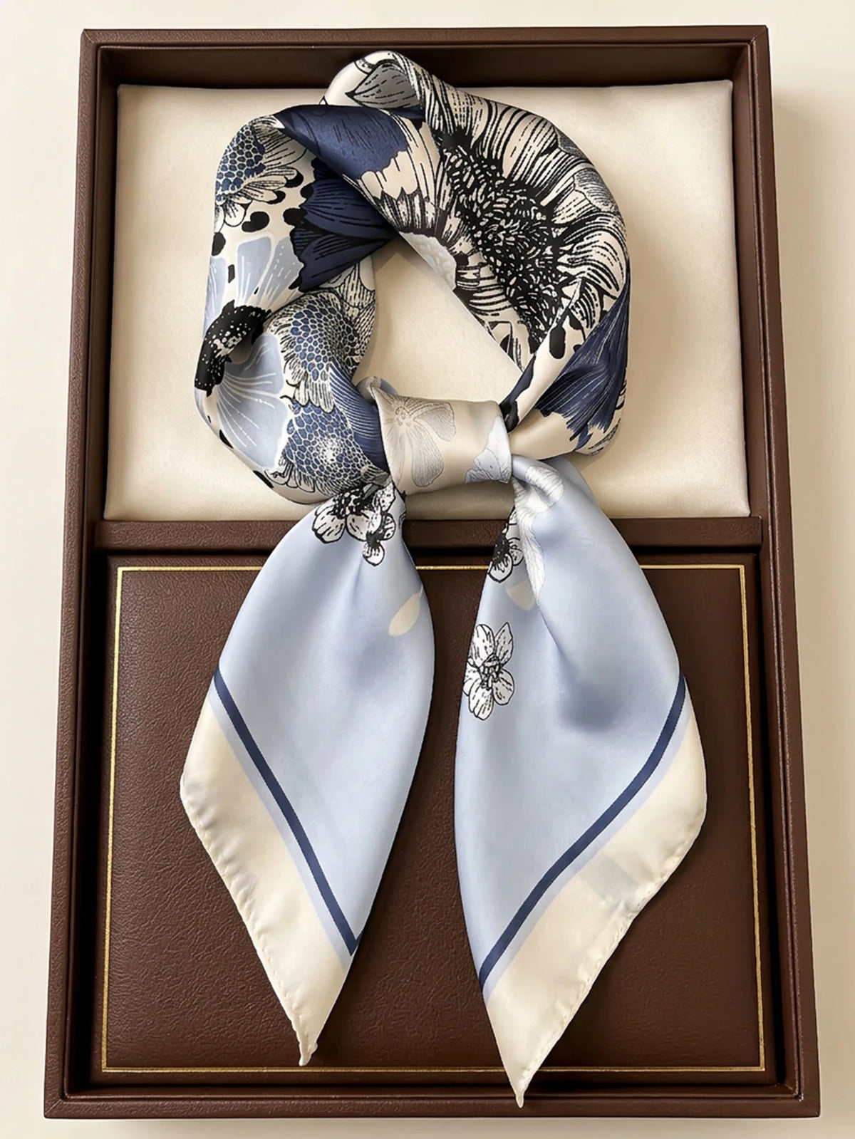 Square silk-like imitation scarf by Corporación Turística, featuring a stylish pattern and vibrant colors.