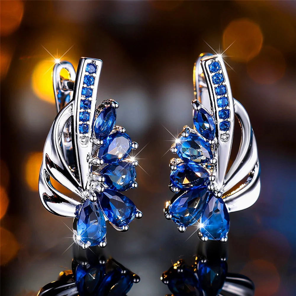Luxury green and blue clip-on earrings for women, featuring elegant jewelry design from Corporación Turística.