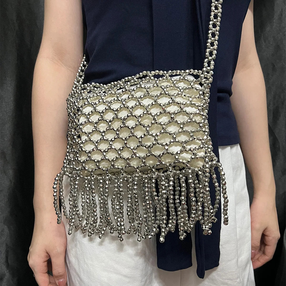 Handmade woven bag with beaded detailing and tassels, featuring a colorful, artisanal design perfect for casual or boho styles.