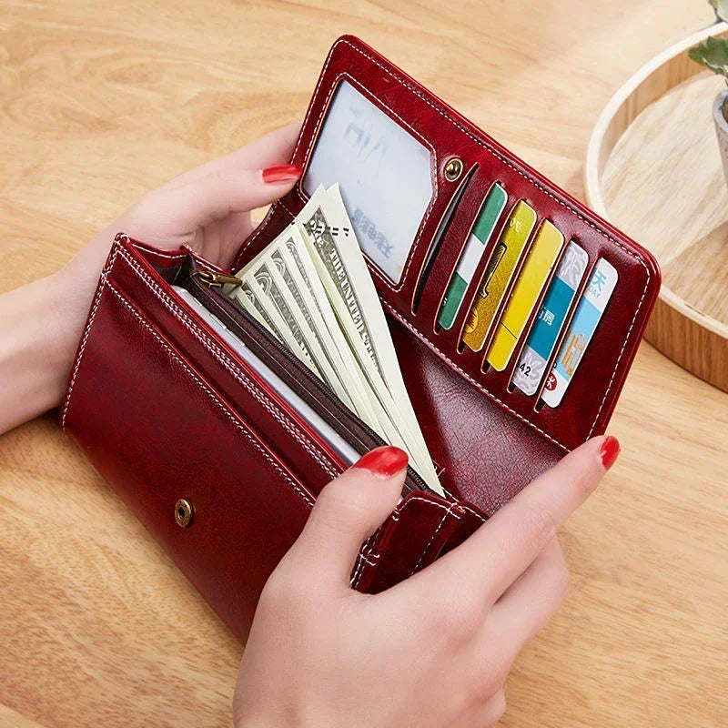 Long women's leather wallet with coin pocket and card slots, stylish black leather accessory by Corporación Turística.