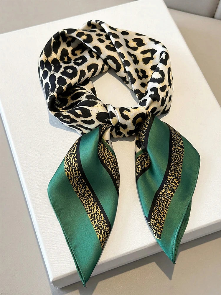 Square silk-like imitation scarf with decorative pattern, featuring vibrant colors and intricate design from Corporación Turística.