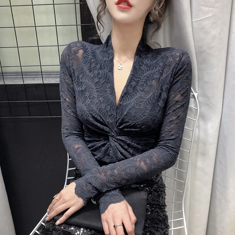 Elegant lace V-neck blouse for women, featuring intricate detailing and a stylish fit from Corporación Turística.