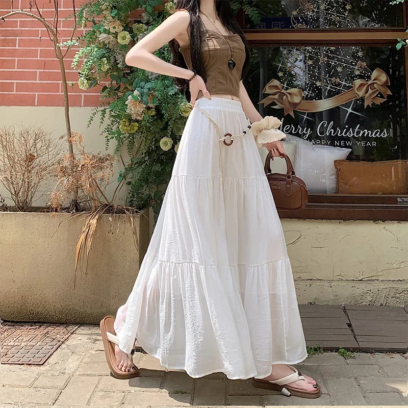 Long boho summer midi skirt made of cotton and linen by Corporación Turística, featuring flowing fabric and ankle-length design.