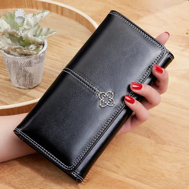 Long women's leather wallet by Corporación Turística with coin pocket and card slots, featuring a sleek, durable design.