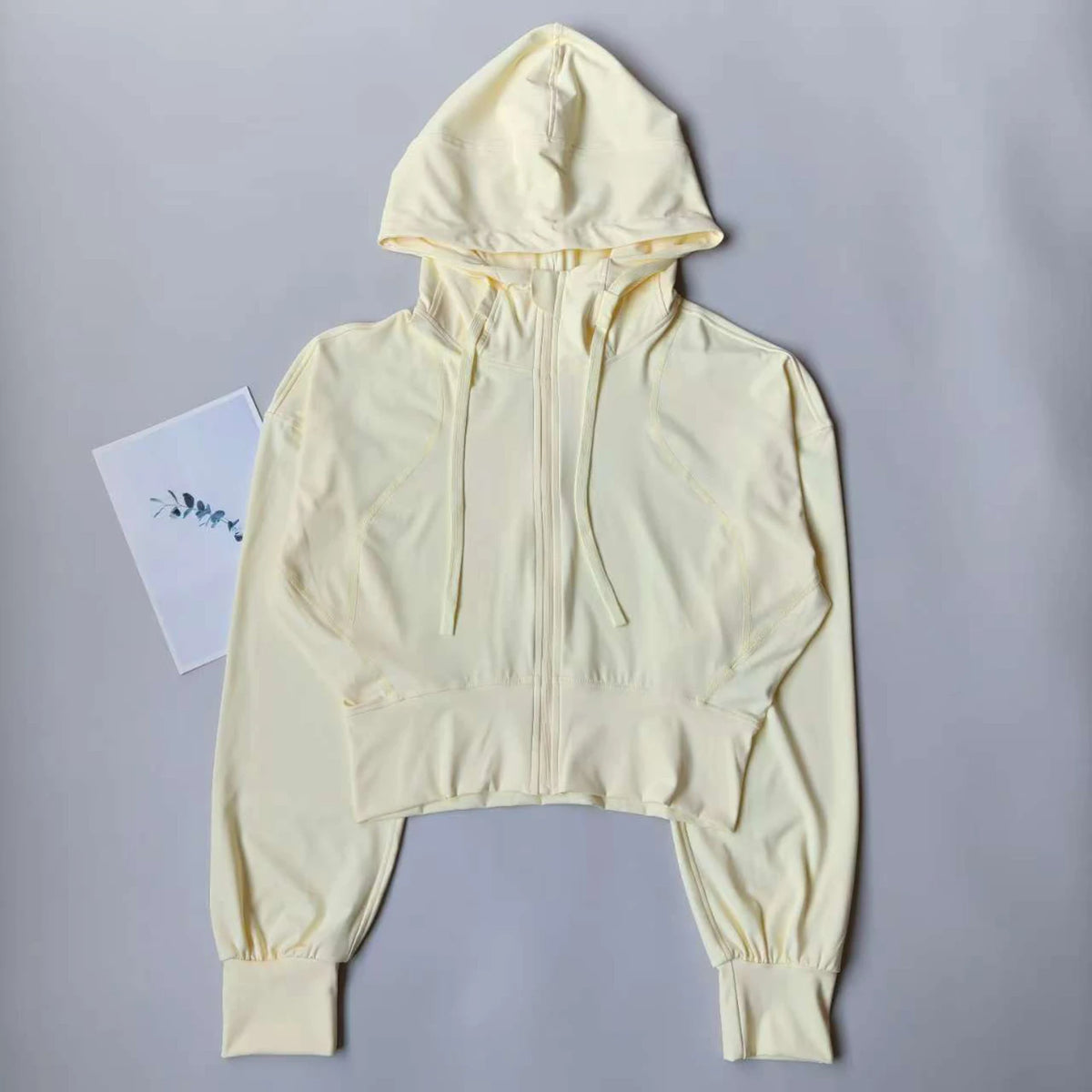 Black women's breathable sports jacket for running and yoga, designed by Corporación Turística, lightweight and comfortable.