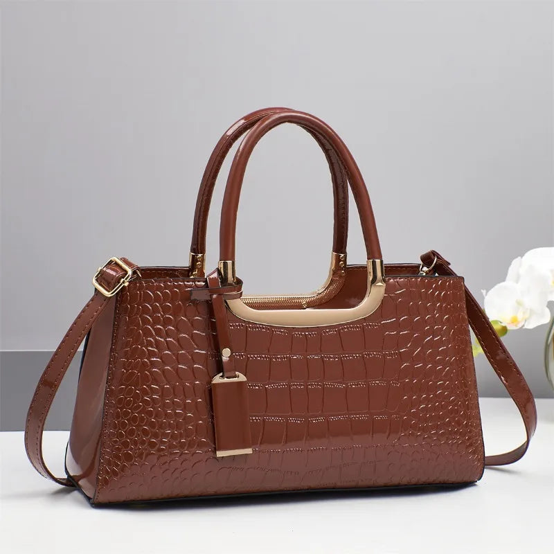 Western-style women's shoulder bag by Corporación Turística, featuring a leather design with detailed stitching and a compact shape.